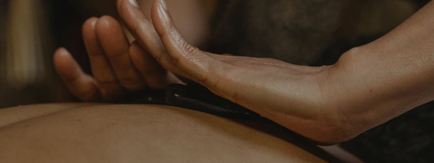 Hands massaging a person's back