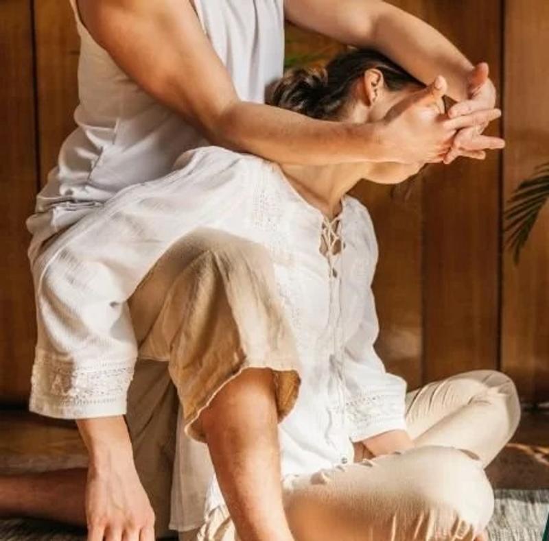 Two people practicing partnered stretching